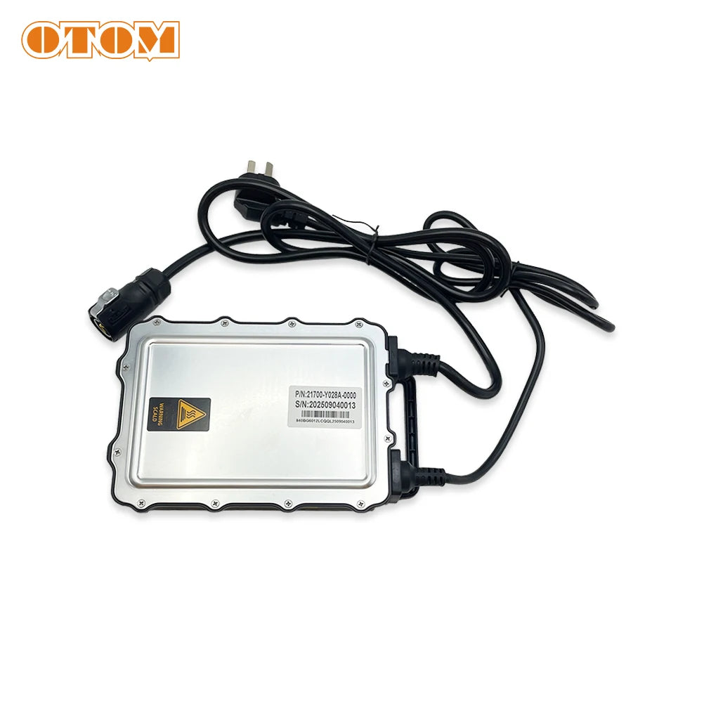 A silver metal automotive electronic control module with a black power cable and connector, shown on a white background with an OTOM logo in the top-left corner.