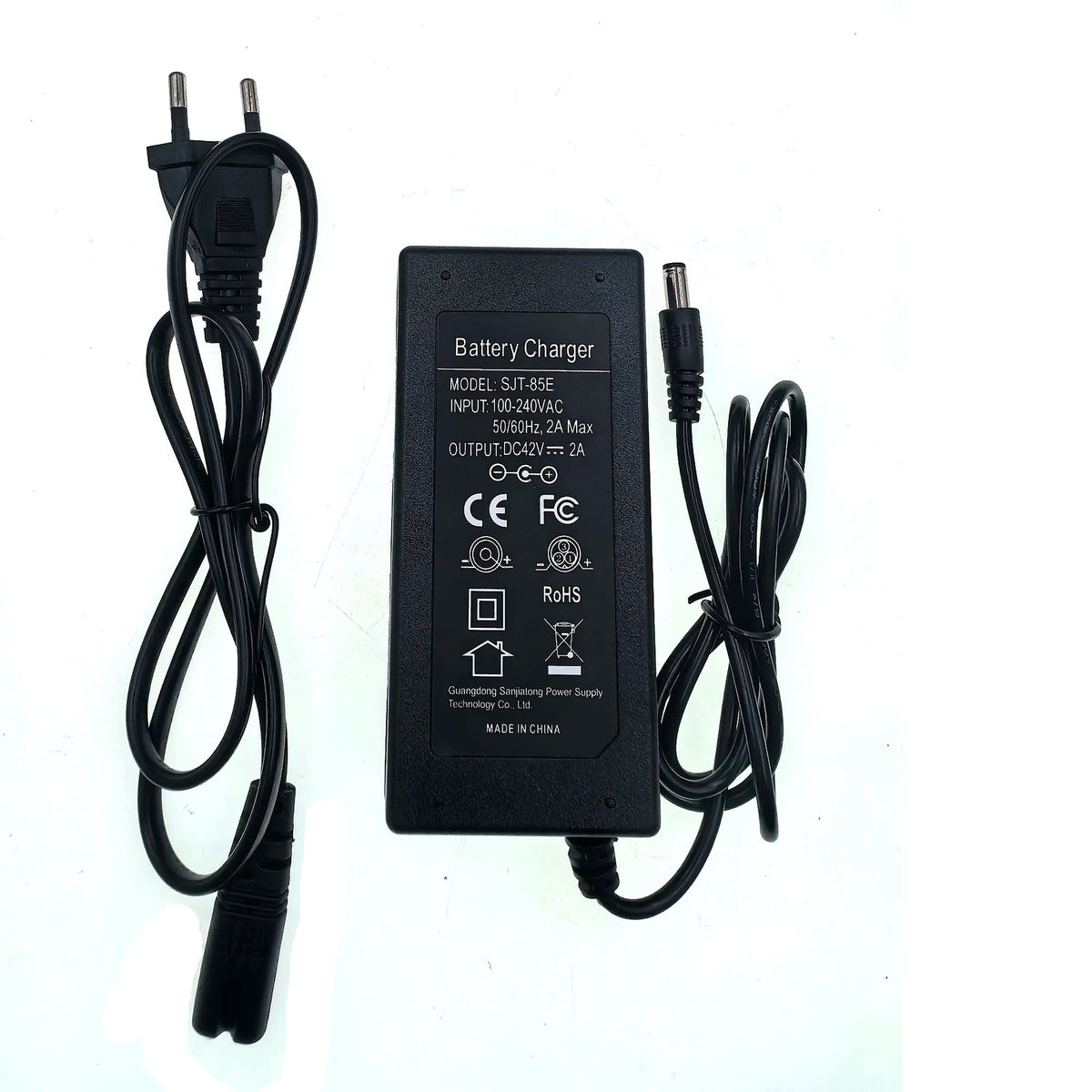 A black DC battery charger adapter with a two-pin plug on one end and a barrel connector on the other, shown on a plain white background. The top of the unit has white printed specifications and certification logos.