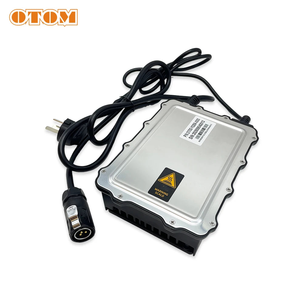 An automotive electronic control module with a silver metal casing and black plastic base, featuring a black power cable with a plug connector. The OTOM logo is visible in the top-left corner.