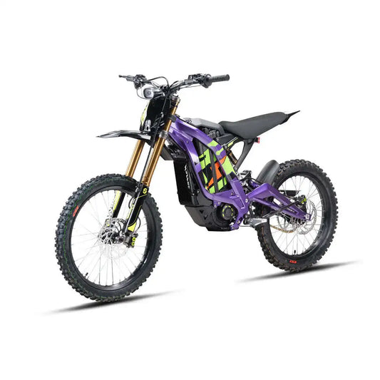 A purple electric dirt bike with black tires, a black seat, and gold front forks, photographed on a clean white background.
