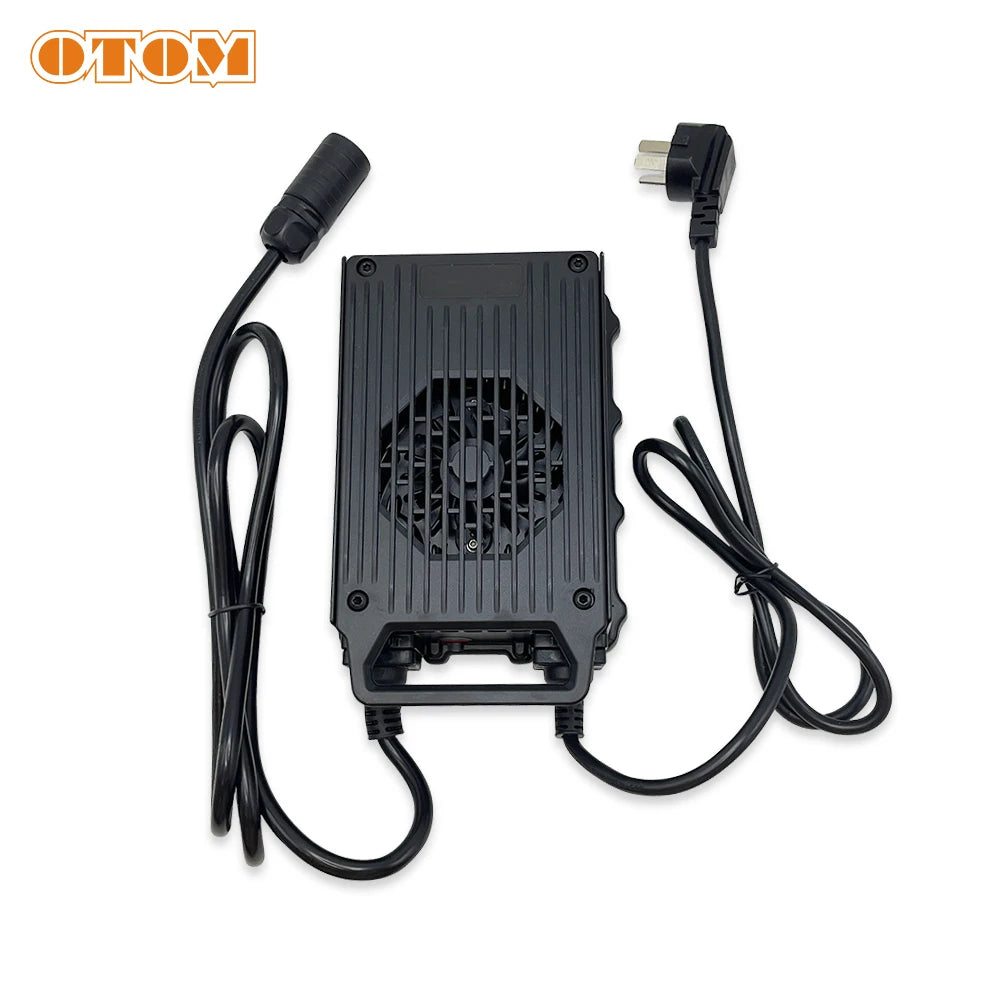 A black electronic controller or adapter with a ribbed housing and attached cables, shown on a plain white background. The OTOM logo appears in the top-left corner.