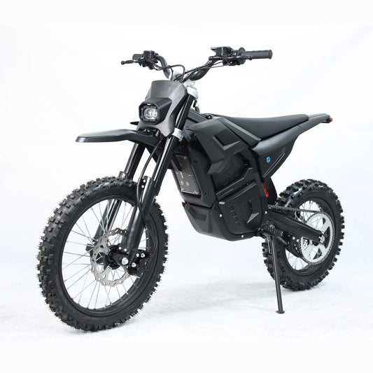 A black electric dirt bike with knobby tires, a high ground clearance suspension, and a central battery pack, photographed on a seamless white studio background.