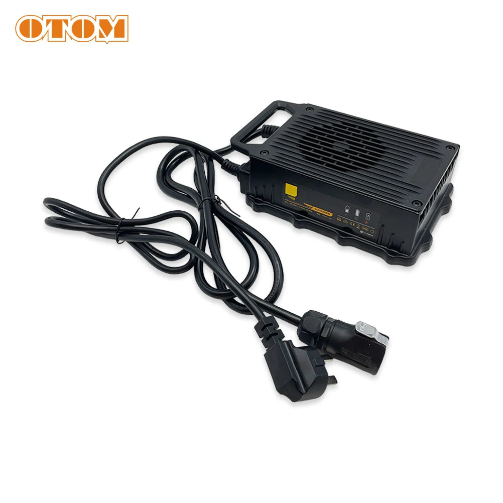 A black rectangular electronic power unit with a cooling vented top, attached to a long black cable and heavy-duty plug, shown on a white background with an OTOM logo in the top left corner.