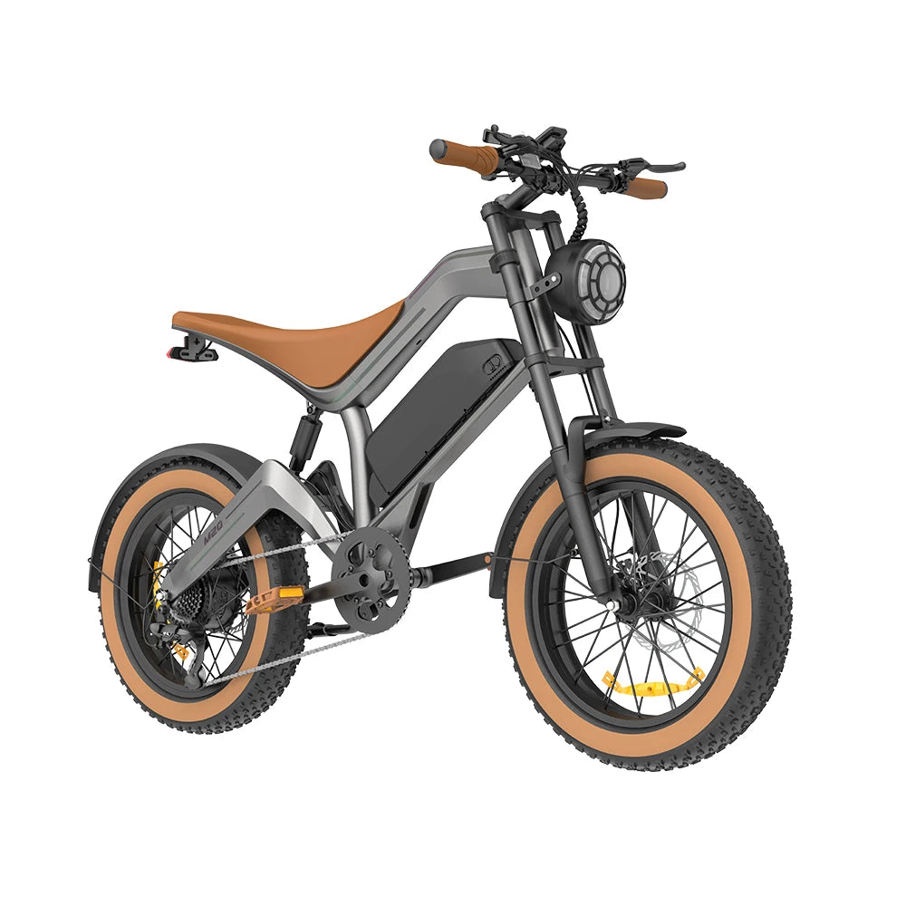 A modern electric fat-tire bicycle with a matte gray frame, brown leather seat and handlebar grips, and tan sidewall tires, shown on a solid white background.