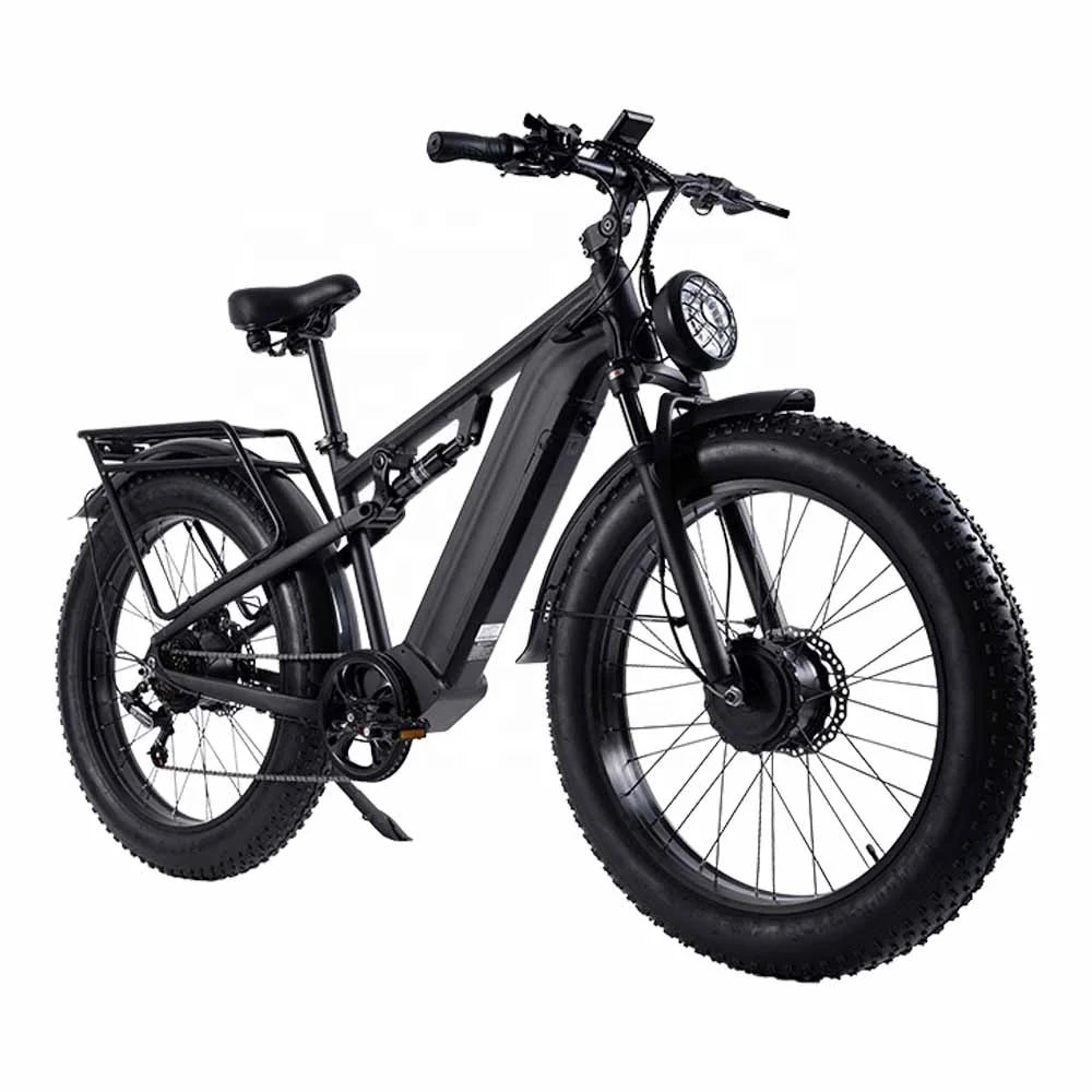 A matte black electric fat tire bicycle with a front headlight, rear rack, and fenders, shown from a three-quarters front angle on a solid white background.