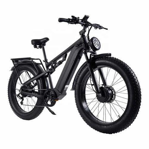 A matte black electric fat tire bicycle with a front headlight, rear rack, and fenders, shown from a three-quarters front angle on a solid white background.