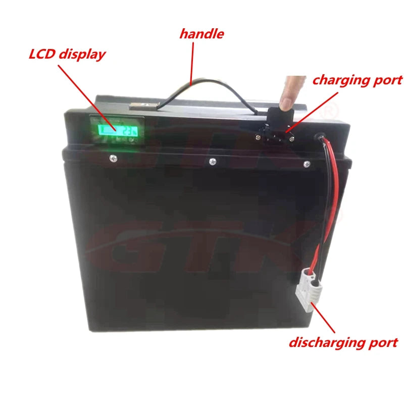 A black rectangular portable battery with a top handle, LCD display, charging port, and discharging port, shown on a white background with red text labels pointing to features.