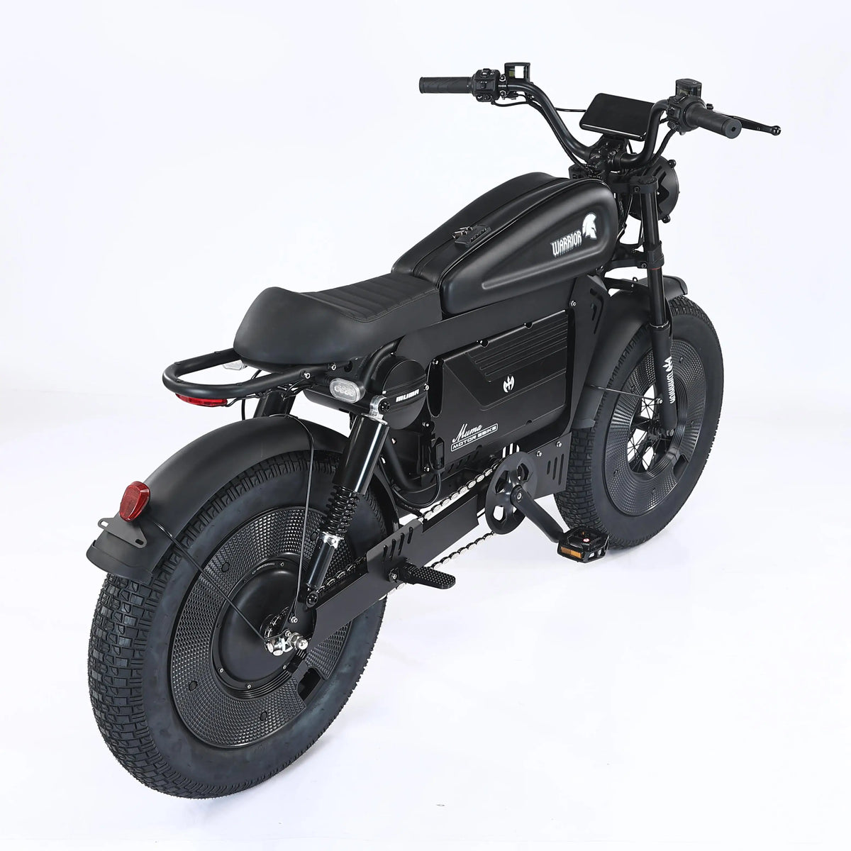 A black electric motorcycle with fat tires, a sleek fuel tank, and a digital display on the handlebar, photographed from a three-quarters rear angle against a white studio background.