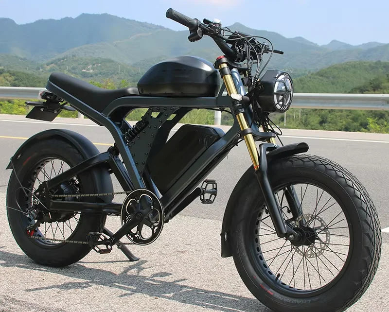 Black electric bike on a road with mountains in the background