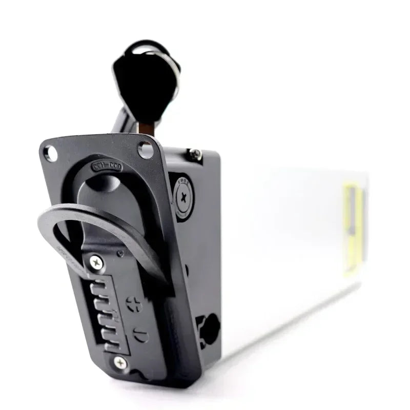 A close-up of a black metal lock mechanism with a key inserted, shown against a clean white background.