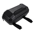 A black bicycle tank bag with a carbon fiber patterned top, black stitching, and two adjustable velcro straps, shown on a plain white background.