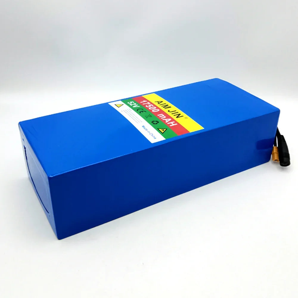 A blue rectangular lithium-ion battery pack with a white, yellow, and green label on top, photographed on a light gray studio background.
