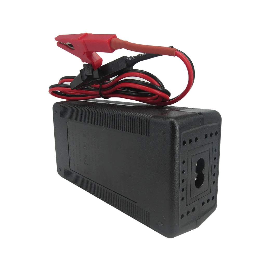 A black rectangular automotive battery charger or power adapter with red and black clamps attached to its leads, shown on a plain white background.