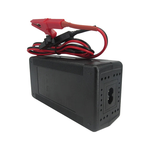 A black rectangular automotive battery charger or power adapter with red and black clamps attached to its leads, shown on a plain white background.