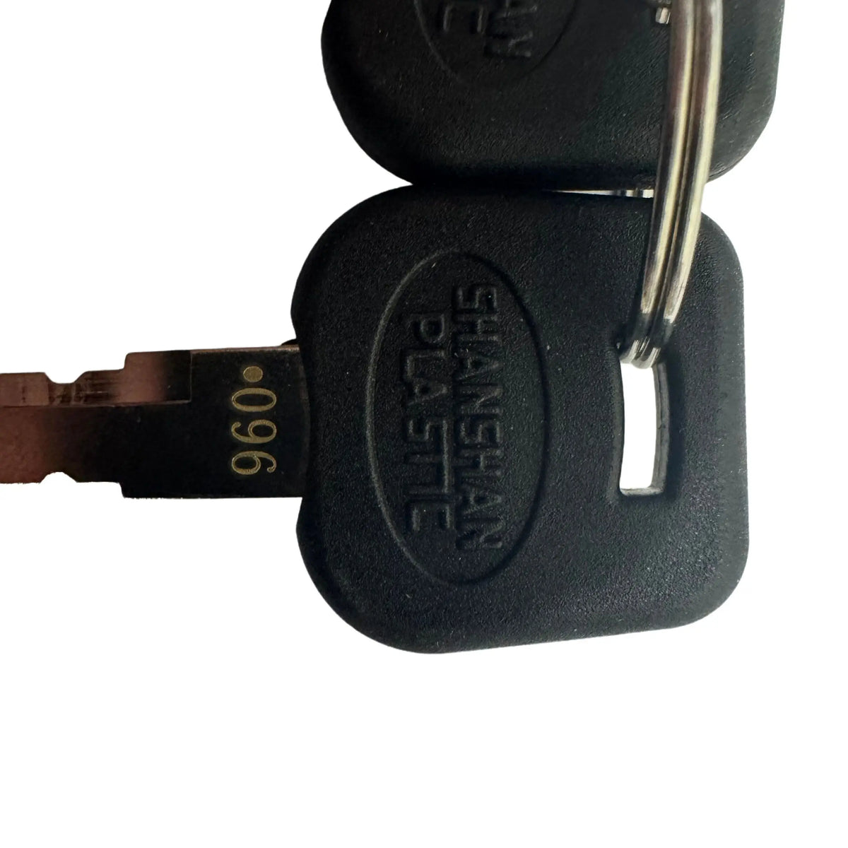 Close-up of a black plastic key fob with an embossed oval logo reading 'SHANSHAN PLASTIC' and a metal key blade stamped with '960'.