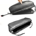 Two views of a black and gray travel pouch with a zipper.