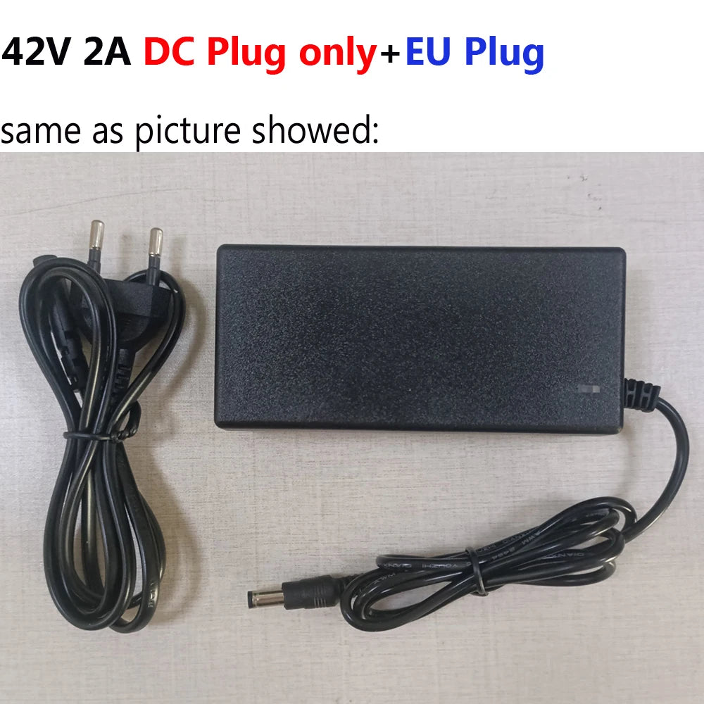 A black 42V 2A DC power adapter with a coiled cable and a EU plug, shown alongside the main adapter block on a light beige textured background. Text at the top reads '42V 2A DC Plug only+EU Plug' and 'same as picture showed:'.