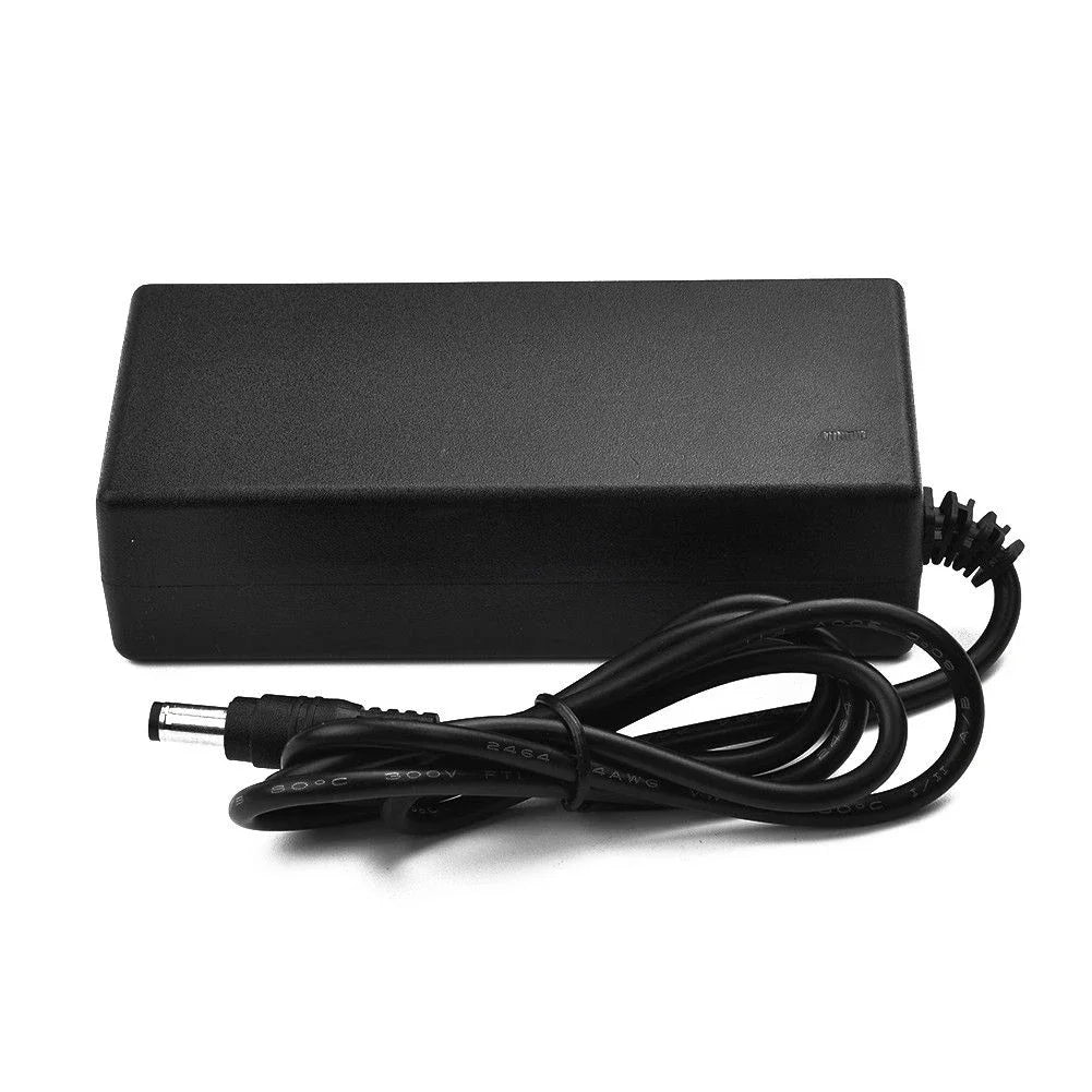 Black rectangular power adapter with a coiled black cable and a barrel-style connector, photographed on a plain white background.