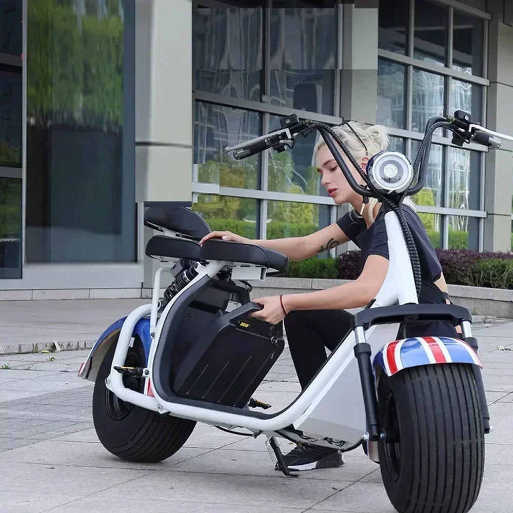 Person sitting on a modern electric scooter in an urban setting
