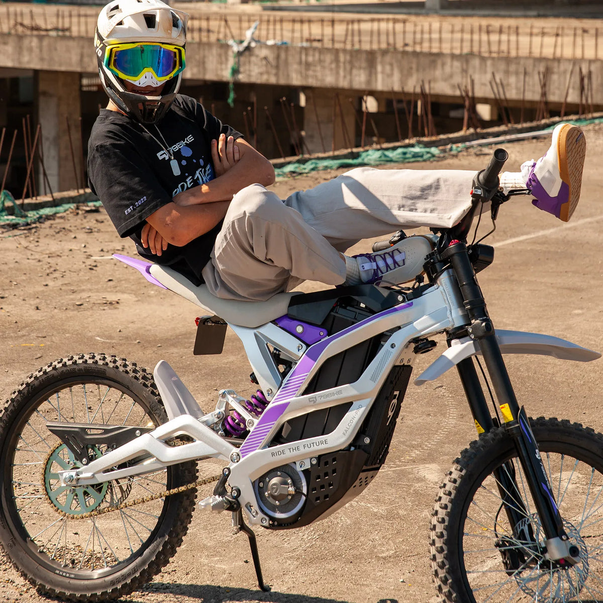 Person sitting on a futuristic electric bike in an outdoor setting