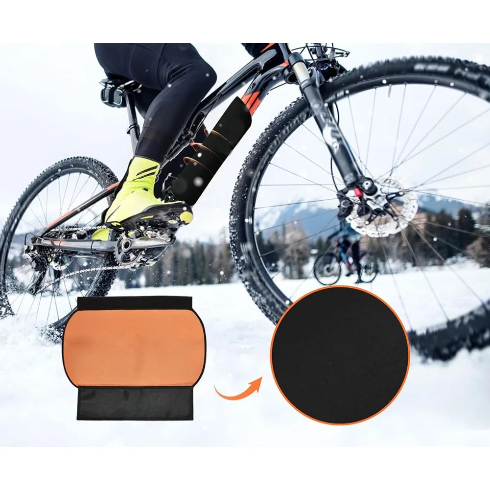 Bicycle with a chain guard in a snowy landscape, showing close-up details.