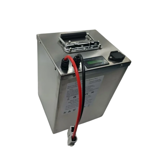 A rectangular silver metal battery with a top handle, a small digital display, a black terminal cap, and red and black cable leads, shown on a plain white background.
