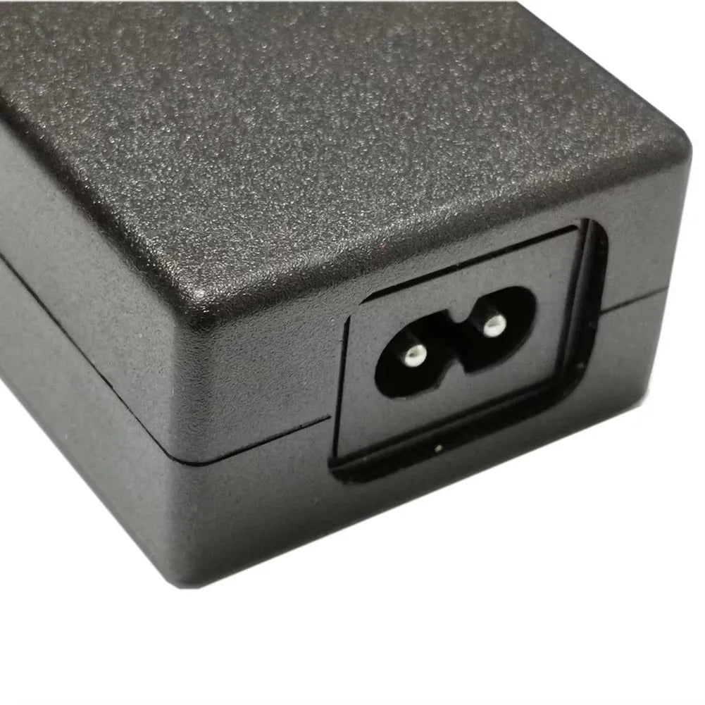 Black electronic device with a power input socket on a white background