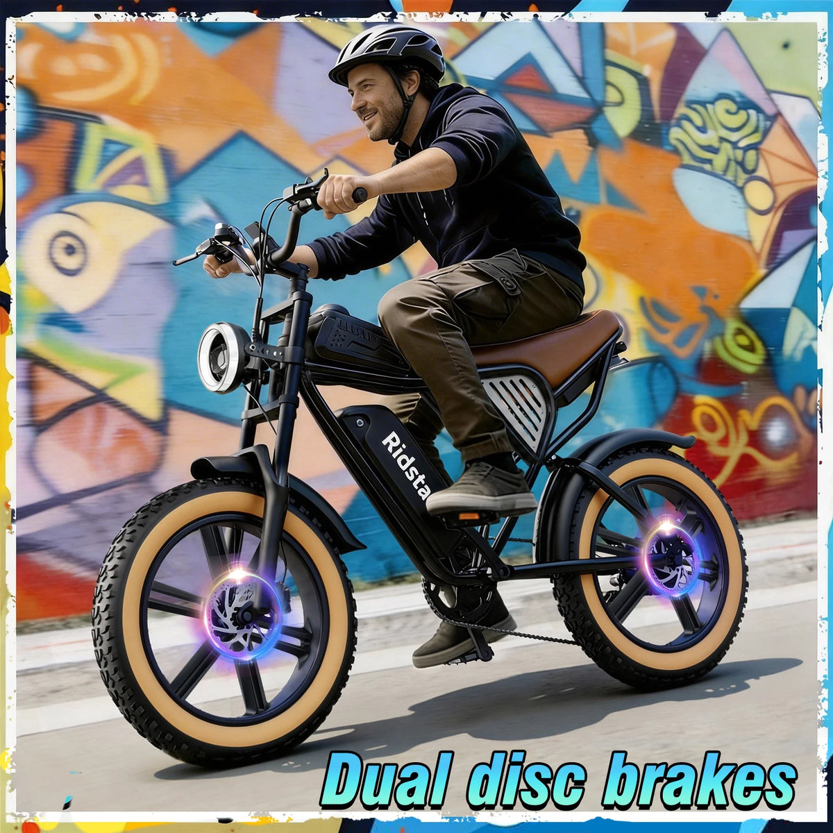 A man riding an electric bicycle in front of a colorful graffiti wall. The bike has a black frame, brown saddle, tan sidewall tires, and glowing purple LED wheel accents.