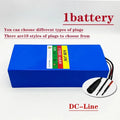 A blue rectangular lithium-ion battery pack with a multicolor label, shown on a white background with text overlays and a circular inset showing included black and red cable connectors.