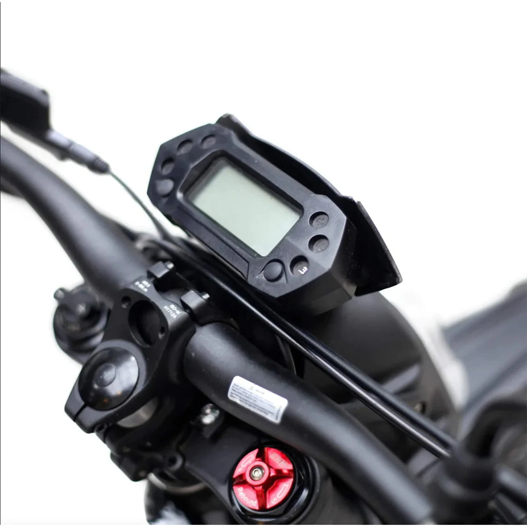 Close-up of a motorcycle handlebar with digital instrument cluster