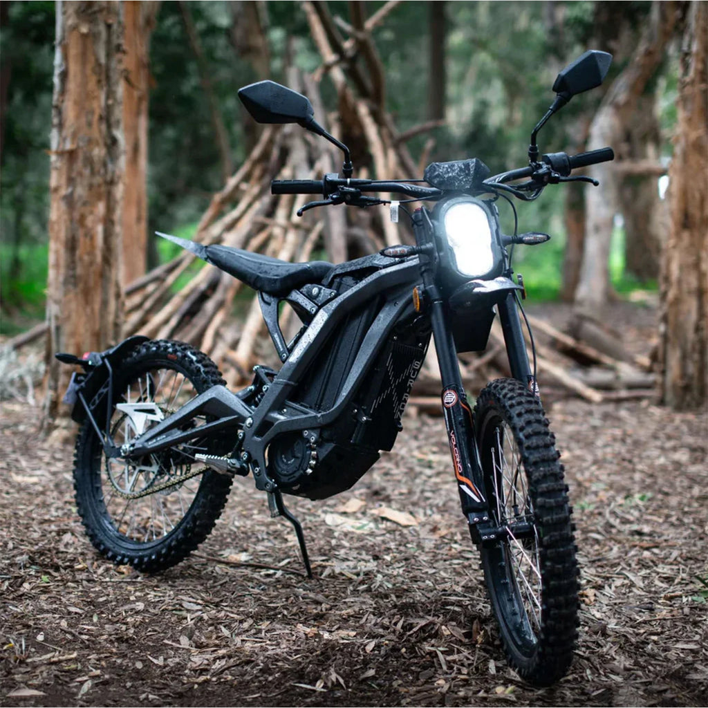 Black off-road motorcycle in a forest setting